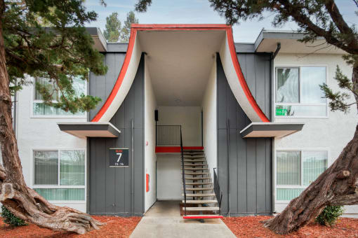 a building with a large asymmetrical doorway and a staircase in front of it