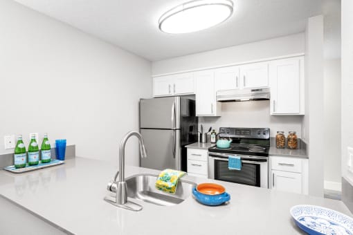 a kitchen with white cabinetry and stainless steel appliances
