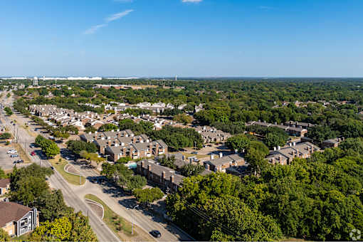 A suburban area with a road and houses.