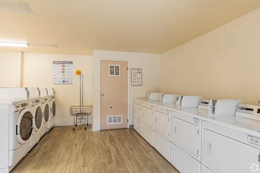 A laundry room with washers and dryers.