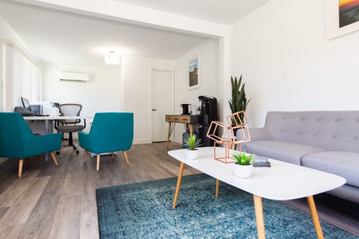 a living room with a couch coffee table and two chairs