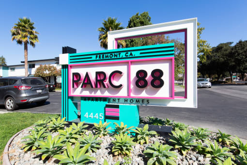 a sign in front of a parking lot