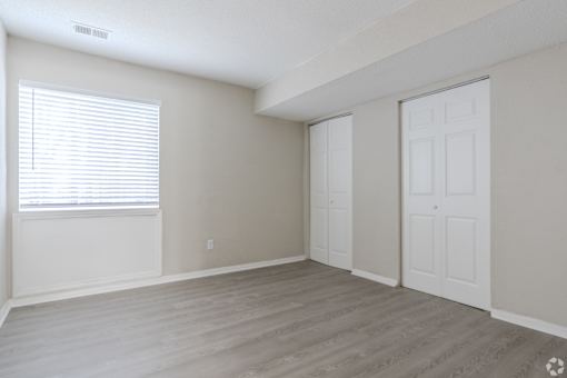 A room with a window and a door.