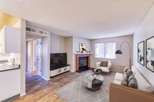 a living room with a fireplace and a tv