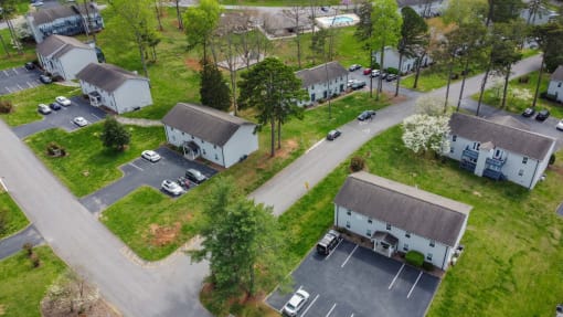 an aerial view of a neighborhood of houses with cars parked