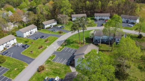 an aerial view of a neighborhood of houses with cars parked