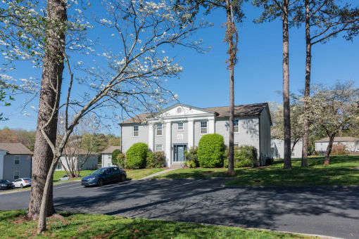 a white house with a car parked in front of it