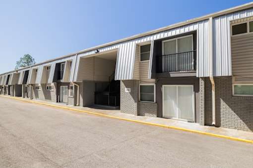 A long building with many windows and doors.
