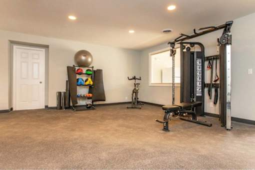 A spacious home gym with a variety of exercise equipment.