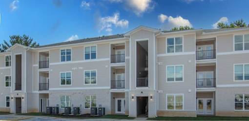 Apartment building with balconies and multiple windows.