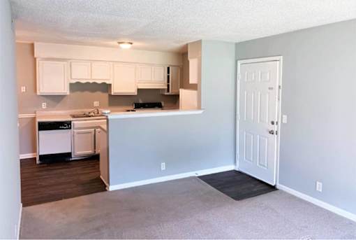 A kitchen with white cabinets and a black stove top oven.