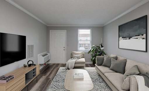 A living room with a couch, a coffee table, a television, and a painting on the wall.