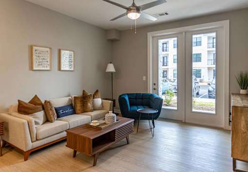 A living room with a couch, chair, and a coffee table.