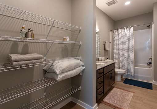 A bathroom with a shower, toilet, and sink.