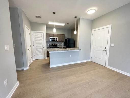A kitchen area with a countertop and cabinets.