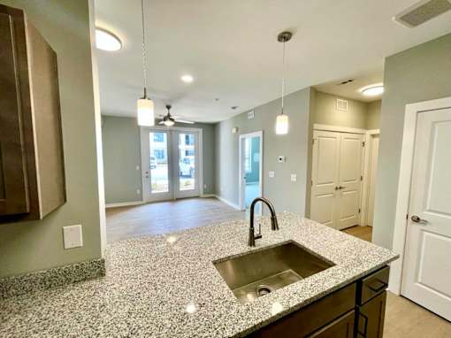 A kitchen with granite countertops and a sink.