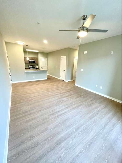 A room with a ceiling fan and light fixture.
