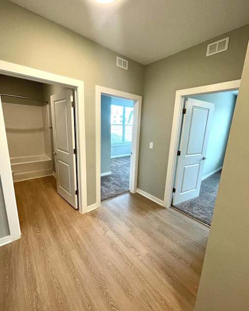 A room with a white door and a window.