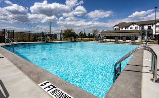 A swimming pool with a 5 ft depth marker.