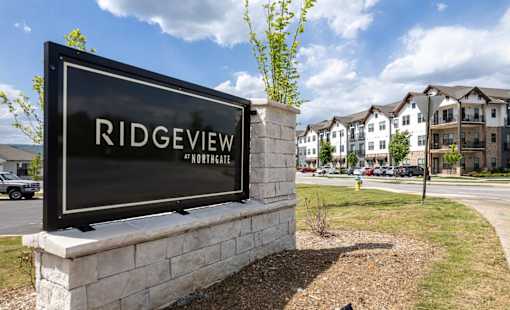 A sign that says Ridgeview Northgate in front of some houses.
