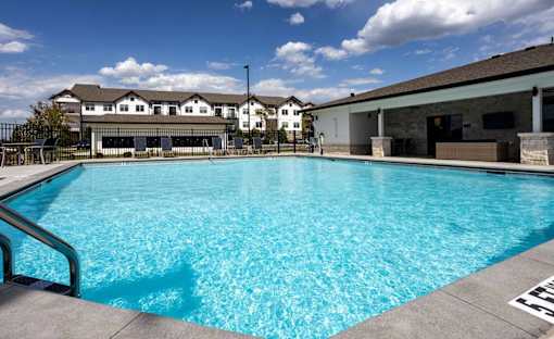 A large swimming pool in front of a building.