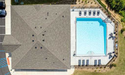 An aerial view of a building with a pool.