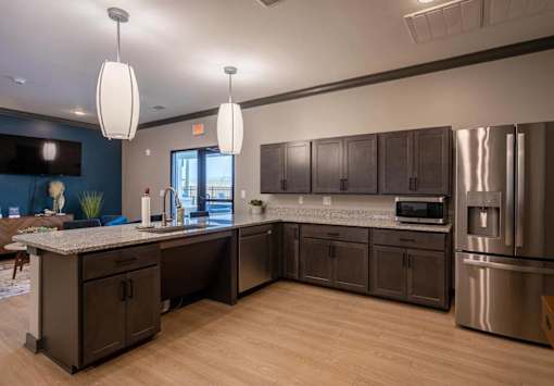 A kitchen with dark brown cabinets and stainless steel appliances.