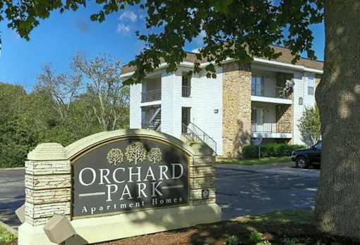 Orchard Park Apartment Homes sign in front of a building.