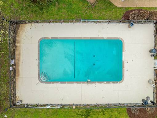 An above ground pool surrounded by a fence.