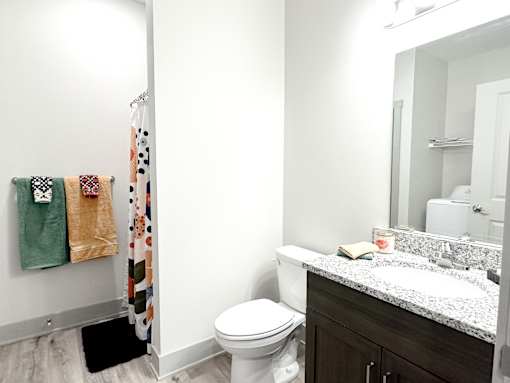 A white toilet sits next to a sink in a bathroom.
