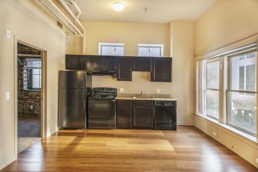 a kitchen with black appliances and black cabinets