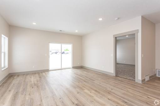 A room with wooden floors and a sliding glass door.