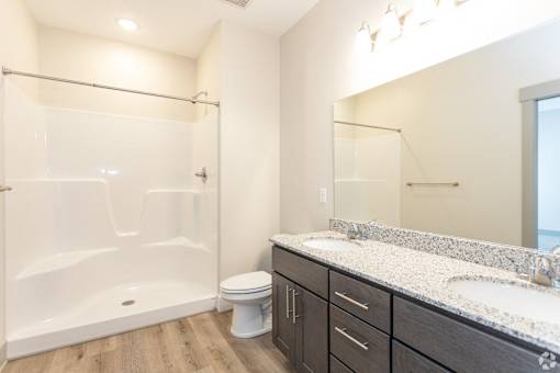 A bathroom with a white tub, sink, and toilet.