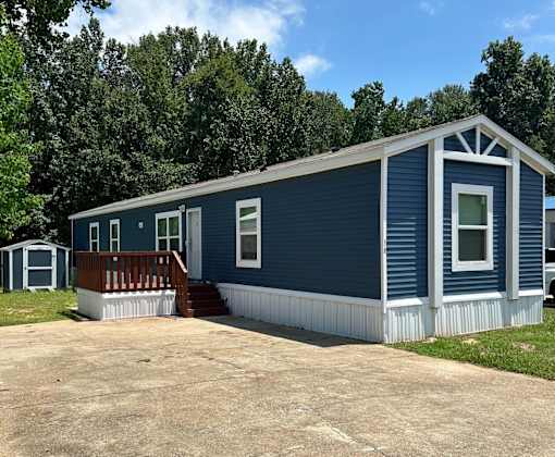 A blue house with a porch and a white door.