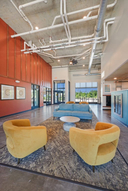 a lobby with couches and chairs and a rug