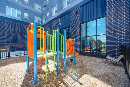 a colorful playground in a courtyard of a building