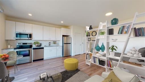 a kitchen and living room with white cabinets