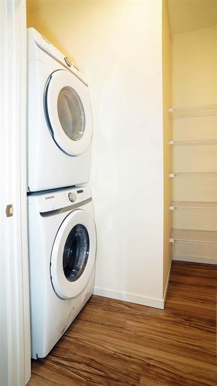 a full size washer and dryer in a room with a wooden floor