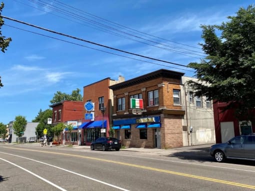 a city street with cars parked on the side of the road