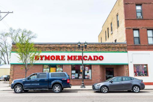 a store with a blue truck parked in front of it