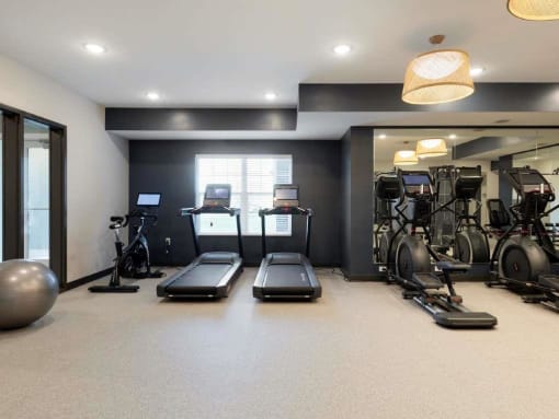 fitness center with treadmills and weight equipment