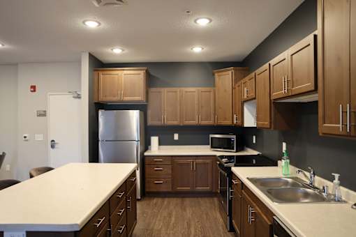 A kitchen with wooden cabinets and a white countertop.