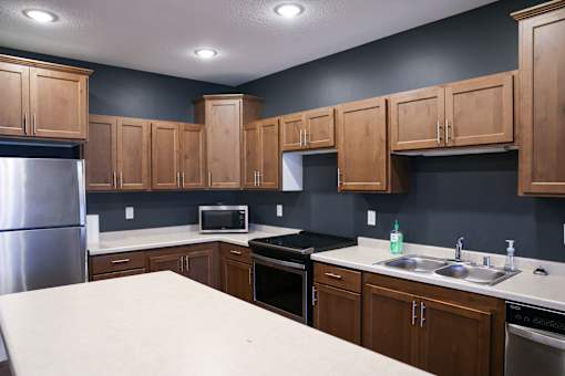 A kitchen with wooden cabinets and a white countertop.