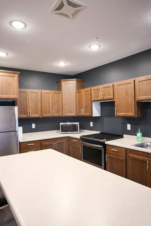 A kitchen with wooden cabinets and a white countertop.