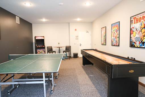 A room with a pool table and a ping pong table.