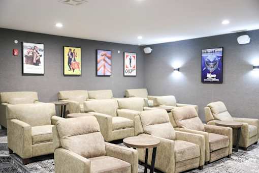 A row of beige recliner chairs are lined up in a room.