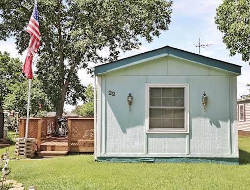 A small blue house with a flag on the left side.