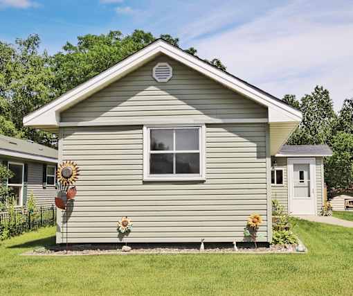 A house with a sunflower decoration on the front.