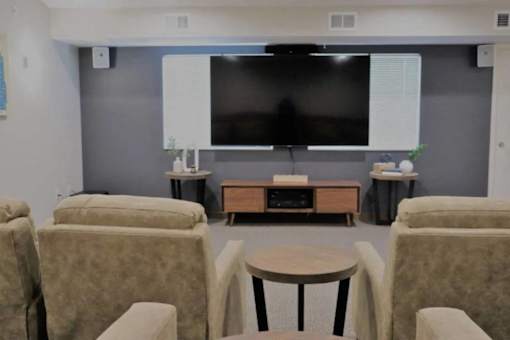 A living room with a television, sofas, and a coffee table.