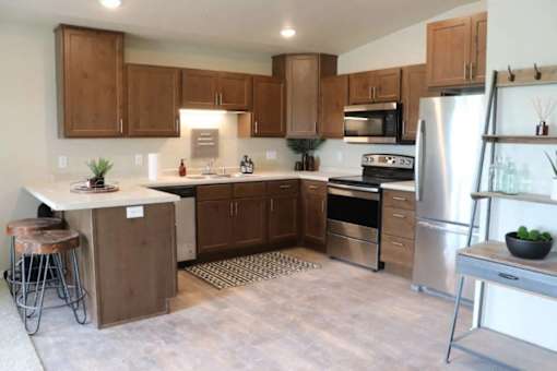 A kitchen with wooden cabinets and stainless steel appliances.